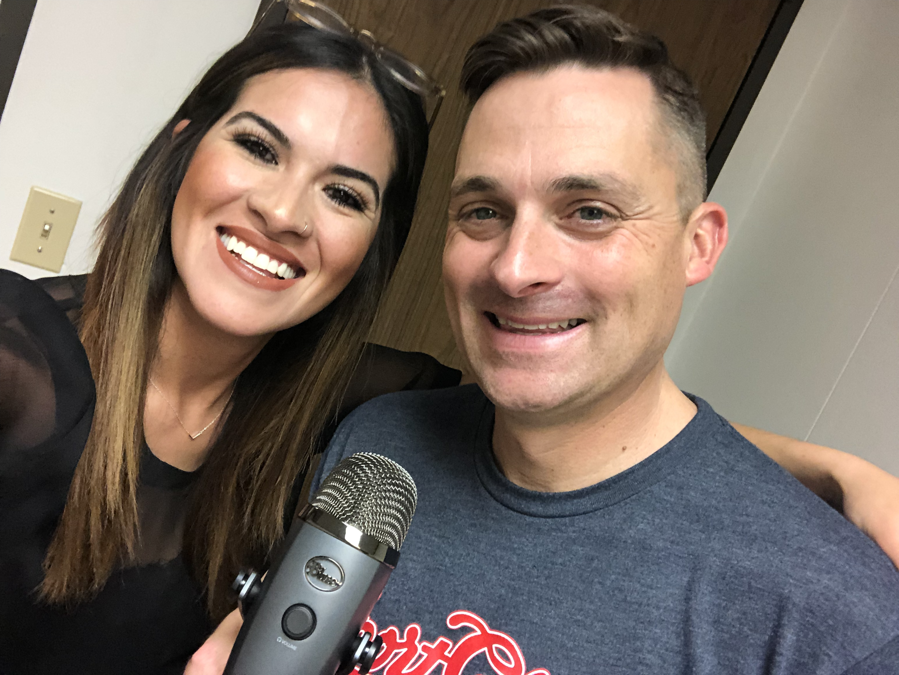 Chad Jordan and Krystle Sierras holding a microphone